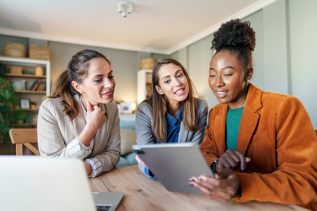 Diverse Female Entrepreneurs Engage in Small Business Planning at Home